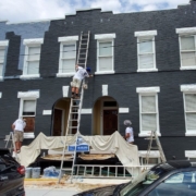 Our team painting on ladders