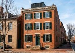 Federal brick rowhouse front with painted shutters in Old Town Alexandria on a clear winter morning