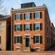 Federal brick rowhouse front with painted shutters in Old Town Alexandria on a clear winter morning